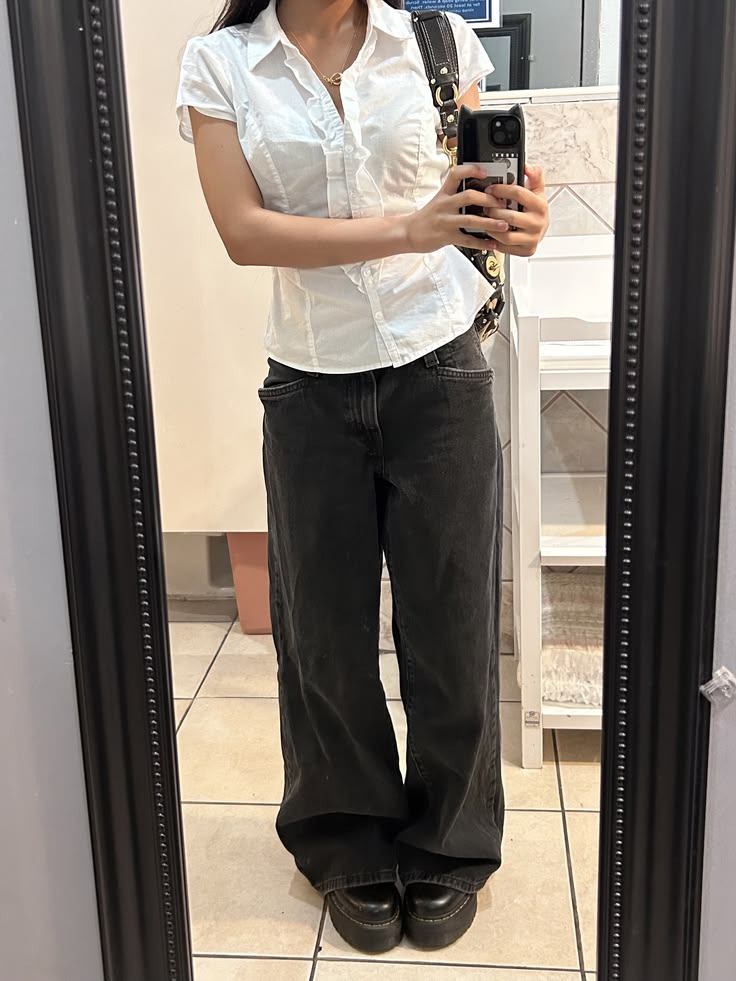 White short-sleeve button-up top with wide-leg black jeans