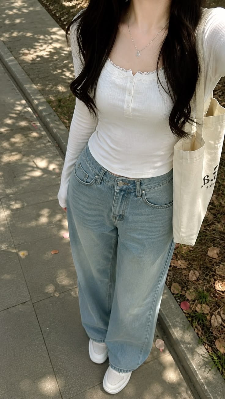White long-sleeve lace-trim top with light blue wide-leg jeans